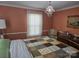 Bedroom with a decorative chandelier and a cozy, patterned quilt at 526 Arlington Ave, Albemarle, NC 28001