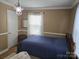 Bedroom featuring neutral walls, wood accents, and natural light from the window at 526 Arlington Ave, Albemarle, NC 28001