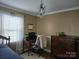 Bedroom with neutral walls, wood accents, desk, and a decorative chandelier at 526 Arlington Ave, Albemarle, NC 28001