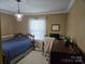 Small bedroom featuring a chandelier and a dark desk at 526 Arlington Ave, Albemarle, NC 28001