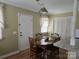 Cozy dining room features an elegant light fixture, hardwood floors, and natural light at 526 Arlington Ave, Albemarle, NC 28001
