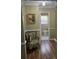 Hallway featuring hardwood floors, light-green painted walls, and a half bathroom at 526 Arlington Ave, Albemarle, NC 28001
