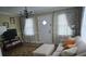 Comfortable living area with a sofa, ottoman, and natural light streaming through the window at 526 Arlington Ave, Albemarle, NC 28001
