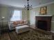 Inviting living room with a decorative chandelier, a classic fireplace, and comfortable seating at 526 Arlington Ave, Albemarle, NC 28001
