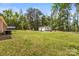 Extensive backyard featuring lush greenery, mature trees, and a charming outbuilding, offering privacy at 5762 Hightower Rd, Fort Lawn, SC 29714