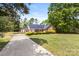 Well-maintained home featuring a long driveway and a cozy, landscaped front yard at 5762 Hightower Rd, Fort Lawn, SC 29714
