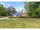 Charming brick home with a blue metal roof, lush green lawn, and manicured landscaping at 5762 Hightower Rd, Fort Lawn, SC 29714