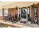 Charming front porch with rocking chairs, decorative plants, and a welcoming entrance at 5762 Hightower Rd, Fort Lawn, SC 29714