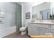 Clean bathroom with a shower-tub combo, a single sink vanity with plenty of light, and modern fixtures at 6215 Honor Ave, Midland, NC 28107