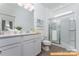 Stylish bathroom featuring double vanity sinks with modern finishes, a glass enclosed shower, and great lighting at 6215 Honor Ave, Midland, NC 28107