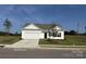 Charming single-story home with a two-car garage, well-manicured lawn, and inviting curb appeal at 6215 Honor Ave, Midland, NC 28107