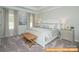 Cozy bedroom featuring a tray ceiling, neutral colors, and large windows providing plenty of natural light at 6215 Honor Ave, Midland, NC 28107