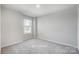 Empty bedroom features a window with natural light at 6427 Mallow Crossing Ln, Charlotte, NC 28213