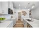 Modern kitchen features white cabinets, stainless appliances, quartz countertops, walk-in pantry, and wood floors at 6427 Mallow Crossing Ln, Charlotte, NC 28213