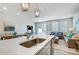 Modern kitchen features stainless appliances, quartz countertops, an island with seating, and an open floor plan at 6427 Mallow Crossing Ln, Charlotte, NC 28213