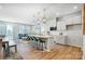 Modern kitchen features white cabinets, stainless appliances, an island with seating, and an open floor plan at 6427 Mallow Crossing Ln, Charlotte, NC 28213