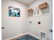 Bright laundry room featuring storage shelves and attractive decor for added convenience at 6427 Mallow Crossing Ln, Charlotte, NC 28213