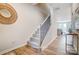Hallway view featuring staircase with carpet steps and wooden floors at 6427 Mallow Crossing Ln, Charlotte, NC 28213