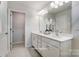 Well lit bathroom featuring double sinks, ample counter space, and modern fixtures at 7144 Hodges Meadow Ln, Charlotte, NC 28213