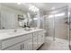 Bright bathroom featuring double sinks, sleek cabinets, and a glass enclosed shower at 7144 Hodges Meadow Ln, Charlotte, NC 28213