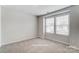 Bright bedroom featuring neutral carpet, light walls, and a window letting in natural light at 7144 Hodges Meadow Ln, Charlotte, NC 28213