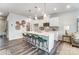 Bright kitchen boasts white cabinetry, an island with seating, and modern pendant lighting at 7144 Hodges Meadow Ln, Charlotte, NC 28213