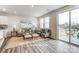 Bright living room featuring neutral tones, stylish furniture, and a sliding glass door to the patio at 7144 Hodges Meadow Ln, Charlotte, NC 28213