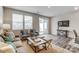 Bright living room featuring neutral tones, stylish furniture, and a sliding glass door to the patio at 7144 Hodges Meadow Ln, Charlotte, NC 28213