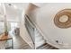Entryway view of staircase with wooden railing and modern decor at 7144 Hodges Meadow Ln, Charlotte, NC 28213