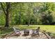 Beautiful backyard with stone fire pit and relaxing seating area at 9607 Stoney Hill Ln, Charlotte, NC 28277