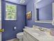 Stylish powder room with blue walls, modern fixtures, and a window view at 9607 Stoney Hill Ln, Charlotte, NC 28277