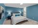 Neutral carpeted bedroom with queen bed, white linens, and blue accent pillows at 9607 Stoney Hill Ln, Charlotte, NC 28277