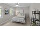 Cozy bedroom with a comfortable bed, soft lighting, and a decorative ladder shelf at 9607 Stoney Hill Ln, Charlotte, NC 28277