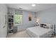 Cozy bedroom showcasing a window view, bookshelf, and comfortable bed at 9607 Stoney Hill Ln, Charlotte, NC 28277