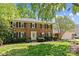 Inviting two-story brick home with black shutters, manicured lawn, and attached garage at 9607 Stoney Hill Ln, Charlotte, NC 28277