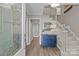 Bright foyer with a stylish blue cabinet, staircase, and wood-look flooring at 9607 Stoney Hill Ln, Charlotte, NC 28277