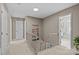Upstairs hallway with carpet, showing access to nearby rooms and bathrooms at 9607 Stoney Hill Ln, Charlotte, NC 28277