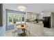Bright kitchen featuring granite countertops, updated appliances, and a breakfast nook at 9607 Stoney Hill Ln, Charlotte, NC 28277
