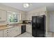 Well-lit kitchen with granite countertops, updated appliances and sink with wooded views at 9607 Stoney Hill Ln, Charlotte, NC 28277