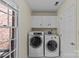 Convenient laundry room with washer, dryer, and storage cabinets at 9607 Stoney Hill Ln, Charlotte, NC 28277