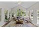 Sunroom boasting lots of natural light, views of the outside, and stylish decor at 9607 Stoney Hill Ln, Charlotte, NC 28277