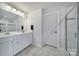 Modern bathroom with double sink vanity, white cabinetry, and a glass-enclosed shower at 1018 Hinson Forest Rd, Monroe, NC 28110