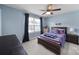 Serene bedroom with blue walls, dark curtains, and a comfortable bed at 1018 Hinson Forest Rd, Monroe, NC 28110