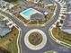 Aerial view of a community pool and clubhouse with landscaping and parking at 1018 Hinson Forest Rd, Monroe, NC 28110