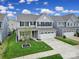 Two-story home with a two-car garage, well-manicured lawn, landscaping, and inviting front porch at 1018 Hinson Forest Rd, Monroe, NC 28110