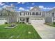 Charming two-story home with a well-manicured lawn and a two-car garage in a suburban neighborhood at 1018 Hinson Forest Rd, Monroe, NC 28110