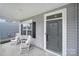 Inviting covered front porch featuring rocking chairs and a view of the home's manicured lawn at 1018 Hinson Forest Rd, Monroe, NC 28110
