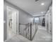Upstairs hallway with natural light, carpet flooring, and a neutral color palette at 1018 Hinson Forest Rd, Monroe, NC 28110