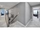 Bright hallway with gray walls, neutral carpet, and a view of rooms on both sides at 1018 Hinson Forest Rd, Monroe, NC 28110