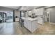 Bright kitchen with white cabinets, stainless appliances, center island, and sliding door to patio at 1018 Hinson Forest Rd, Monroe, NC 28110